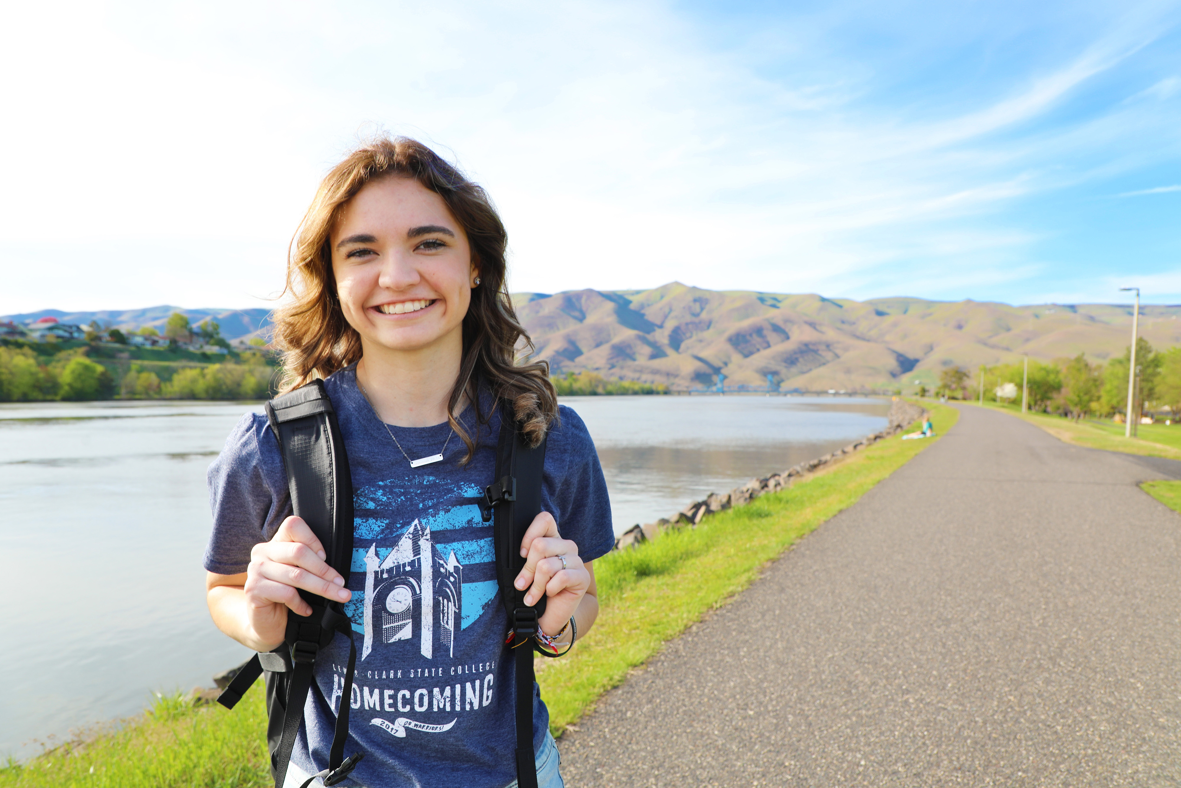 Students smiling while standing along the Snake River bypass 