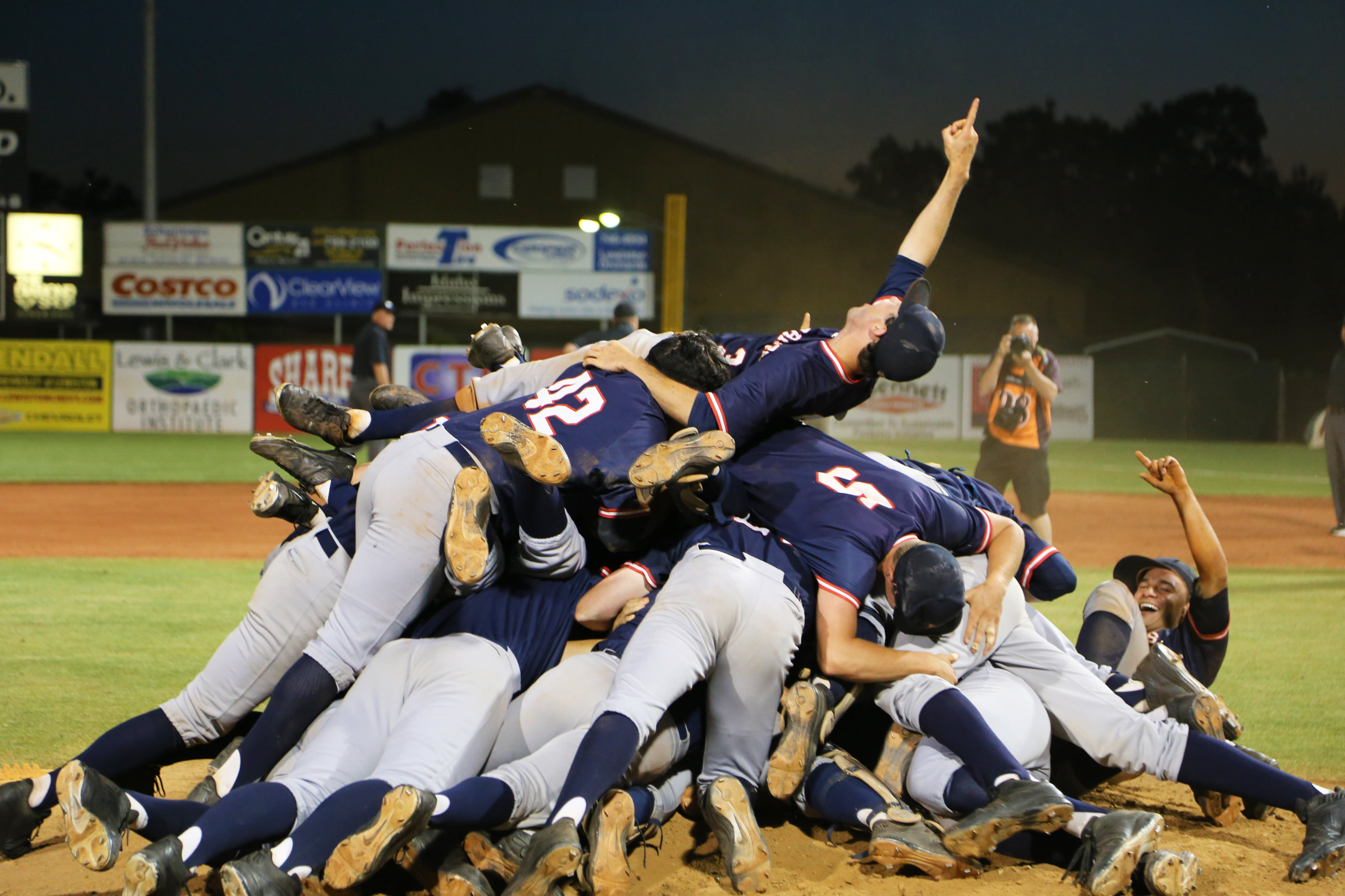LCSC Baseball players dog pile after winning NAIA World Series