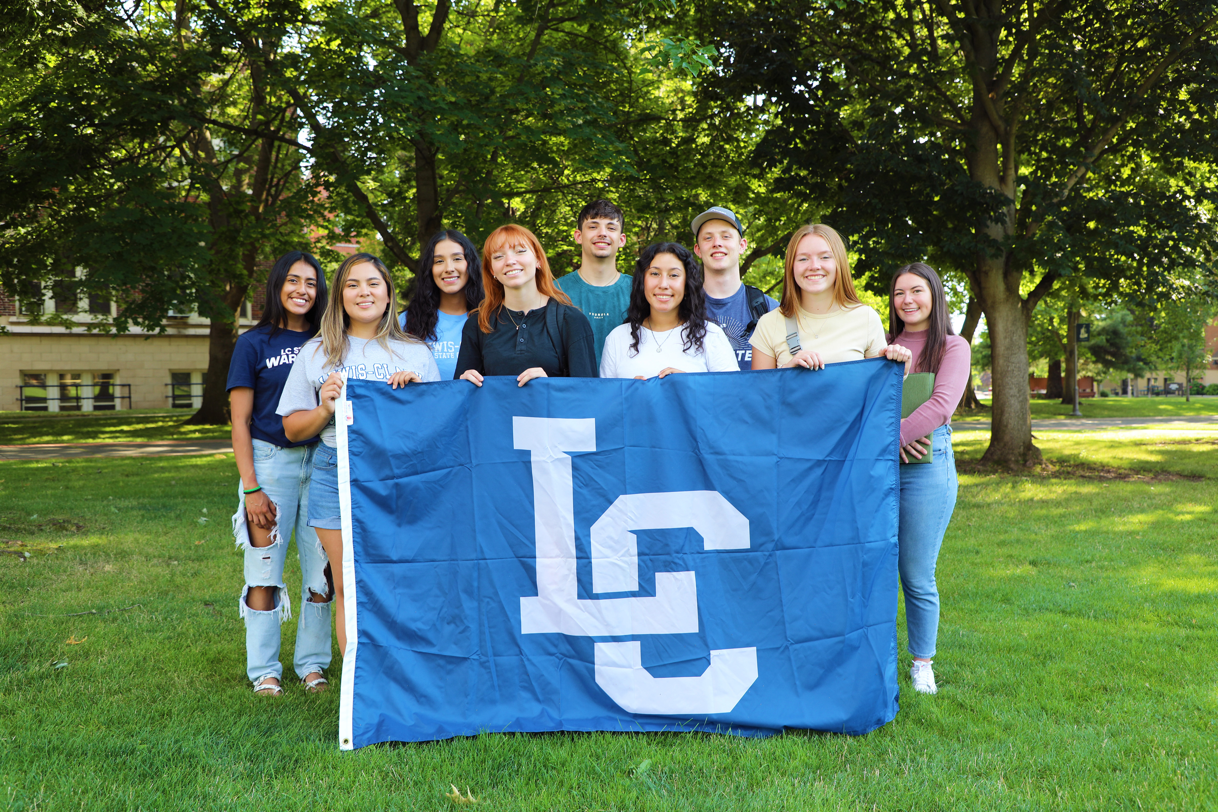 Students holding LC banner