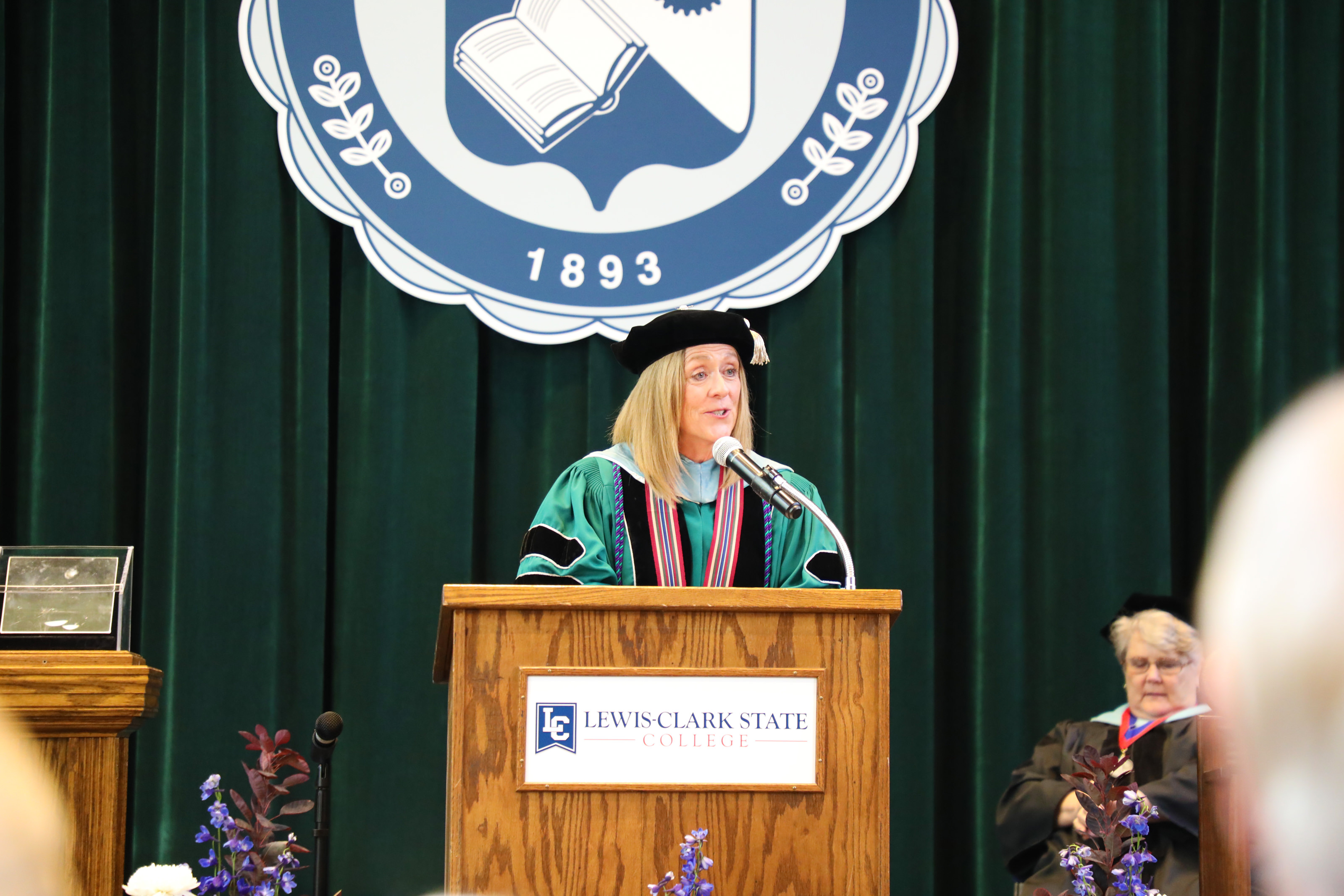 President Pemberton speaking behind podium