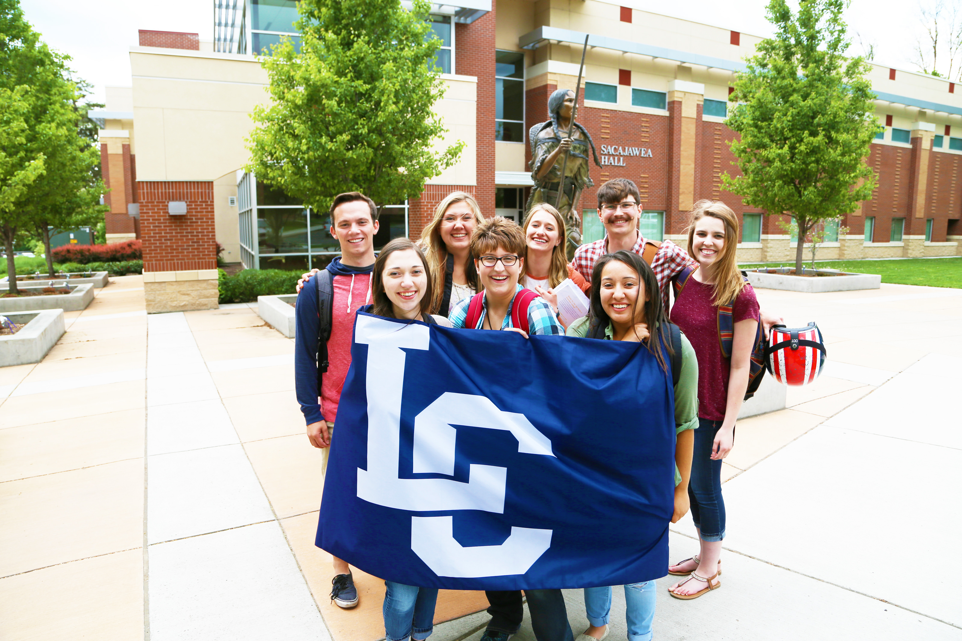 Students holding LC banner
