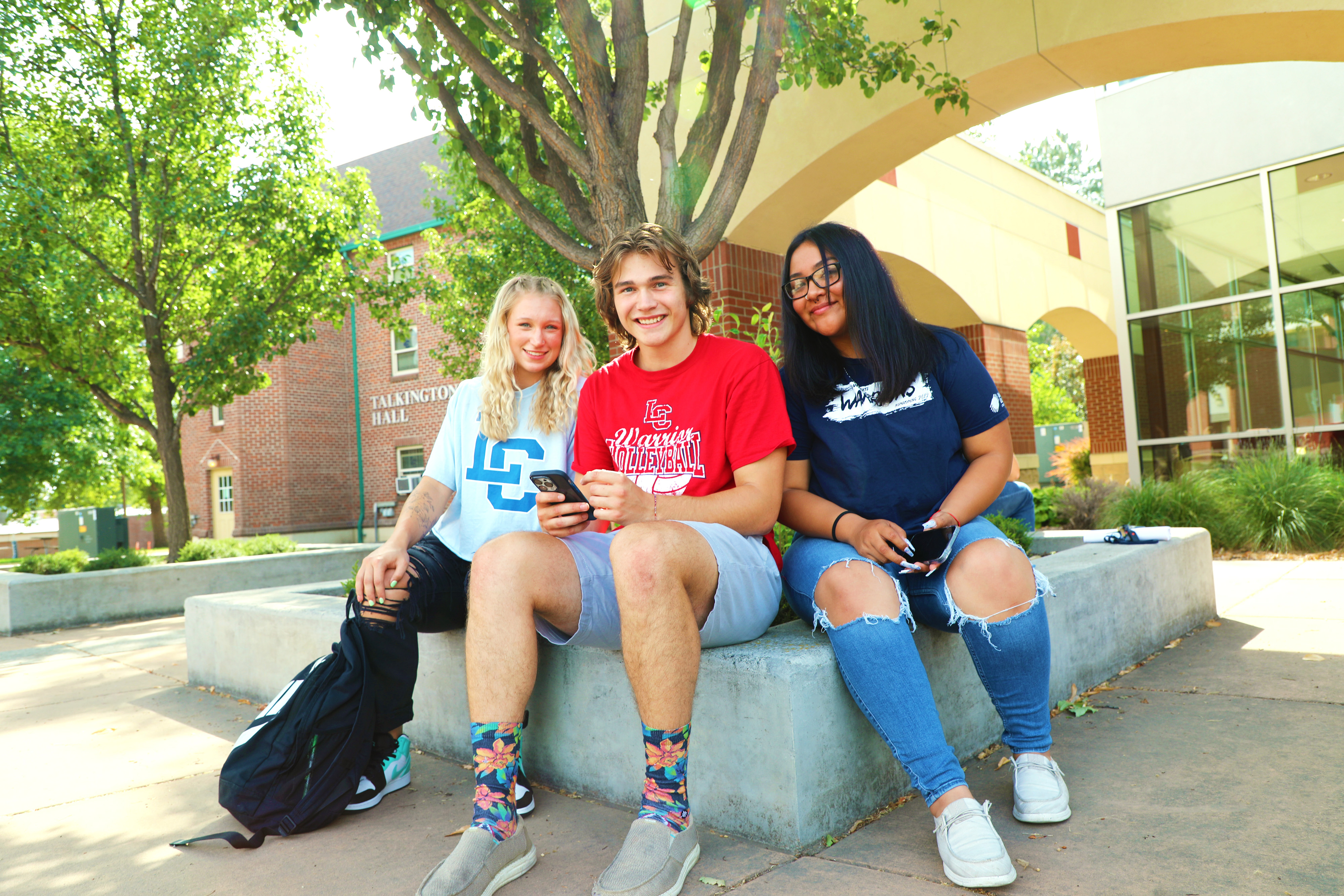 3 LC State students sitting on campus
