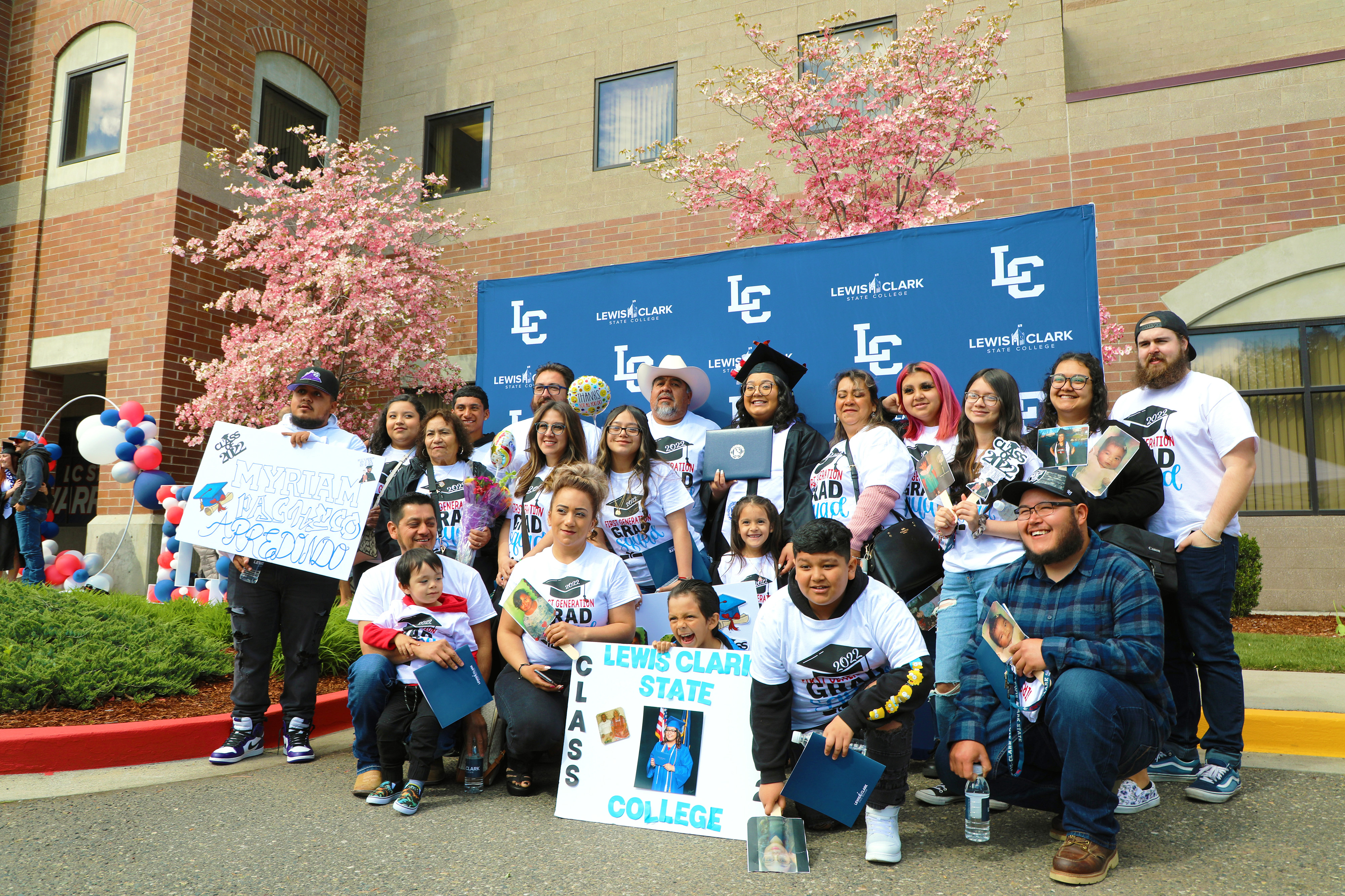 A graduate surrounded by her gamily after commencement