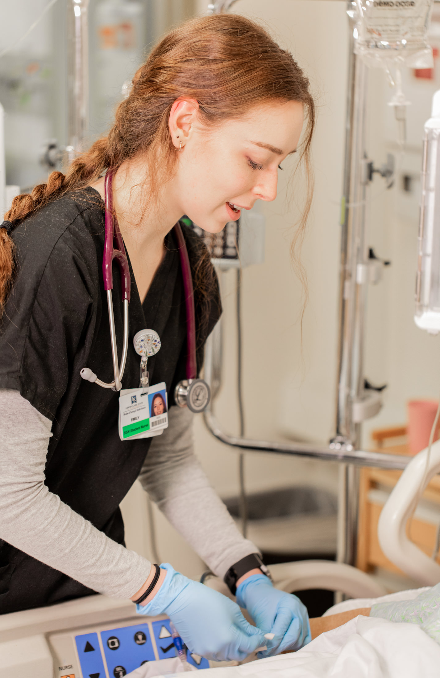 Female nursing student at bedside