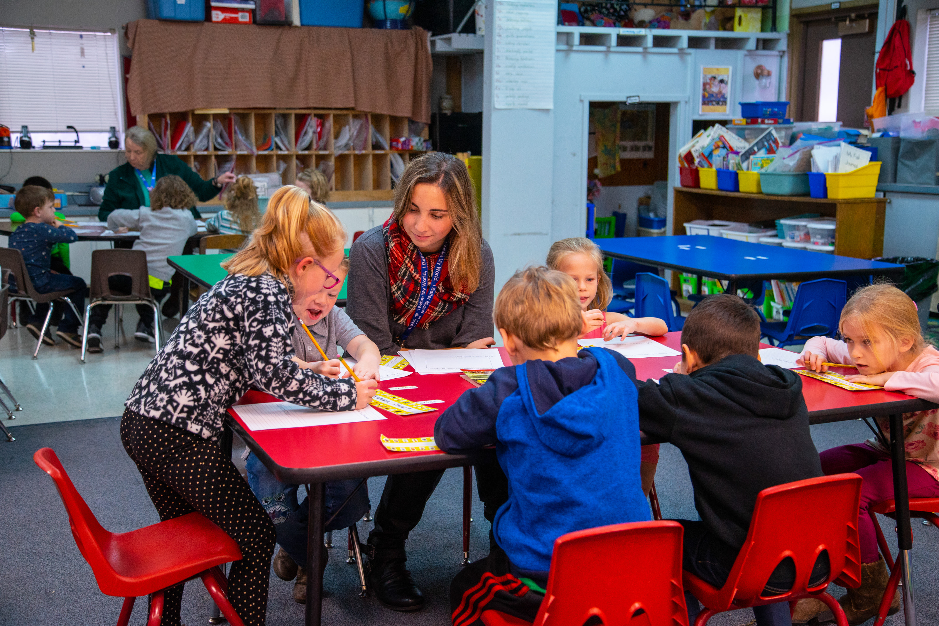 Student teacher with young children in a classroom