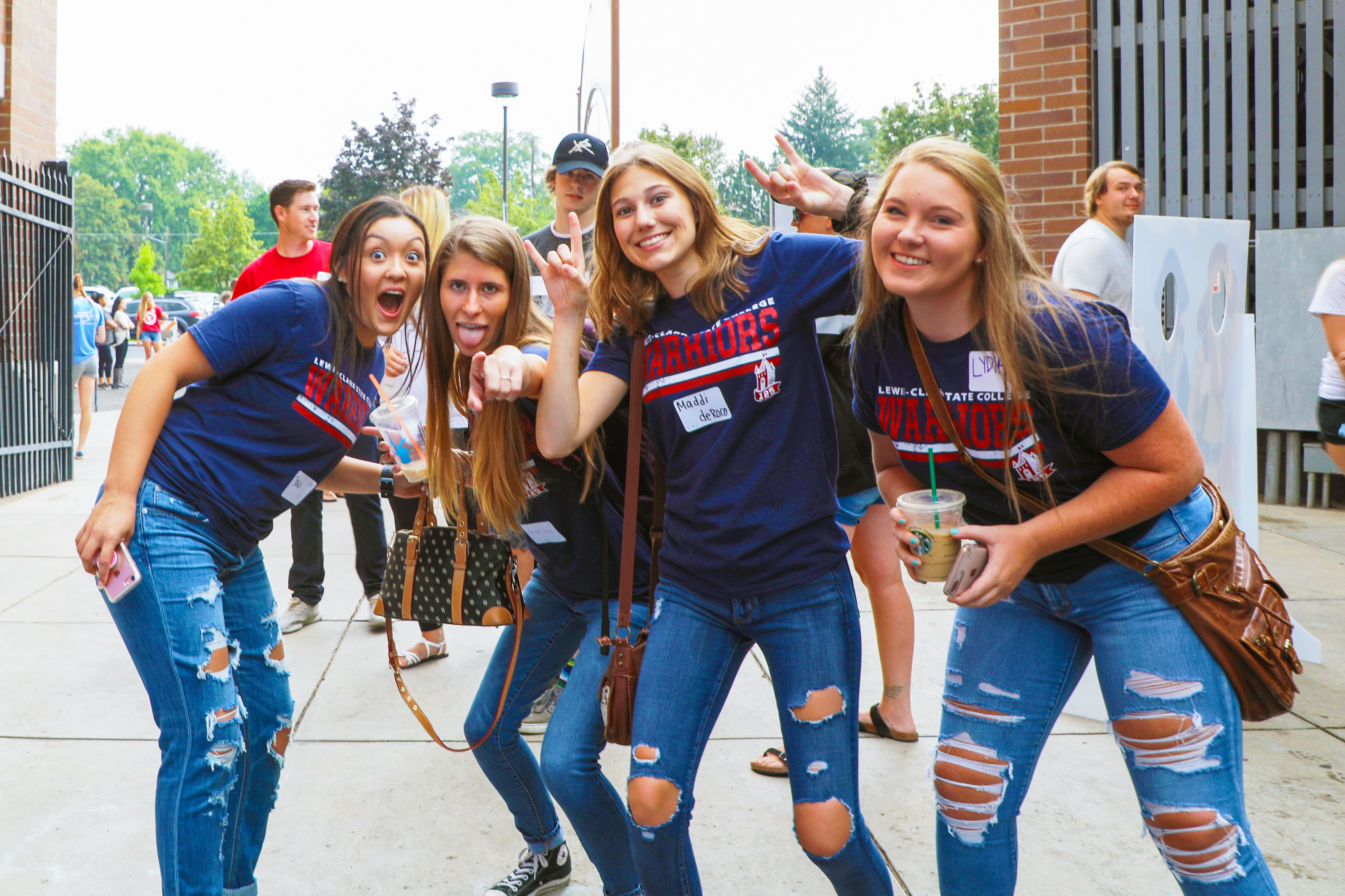 Four female students smiling together at orientation