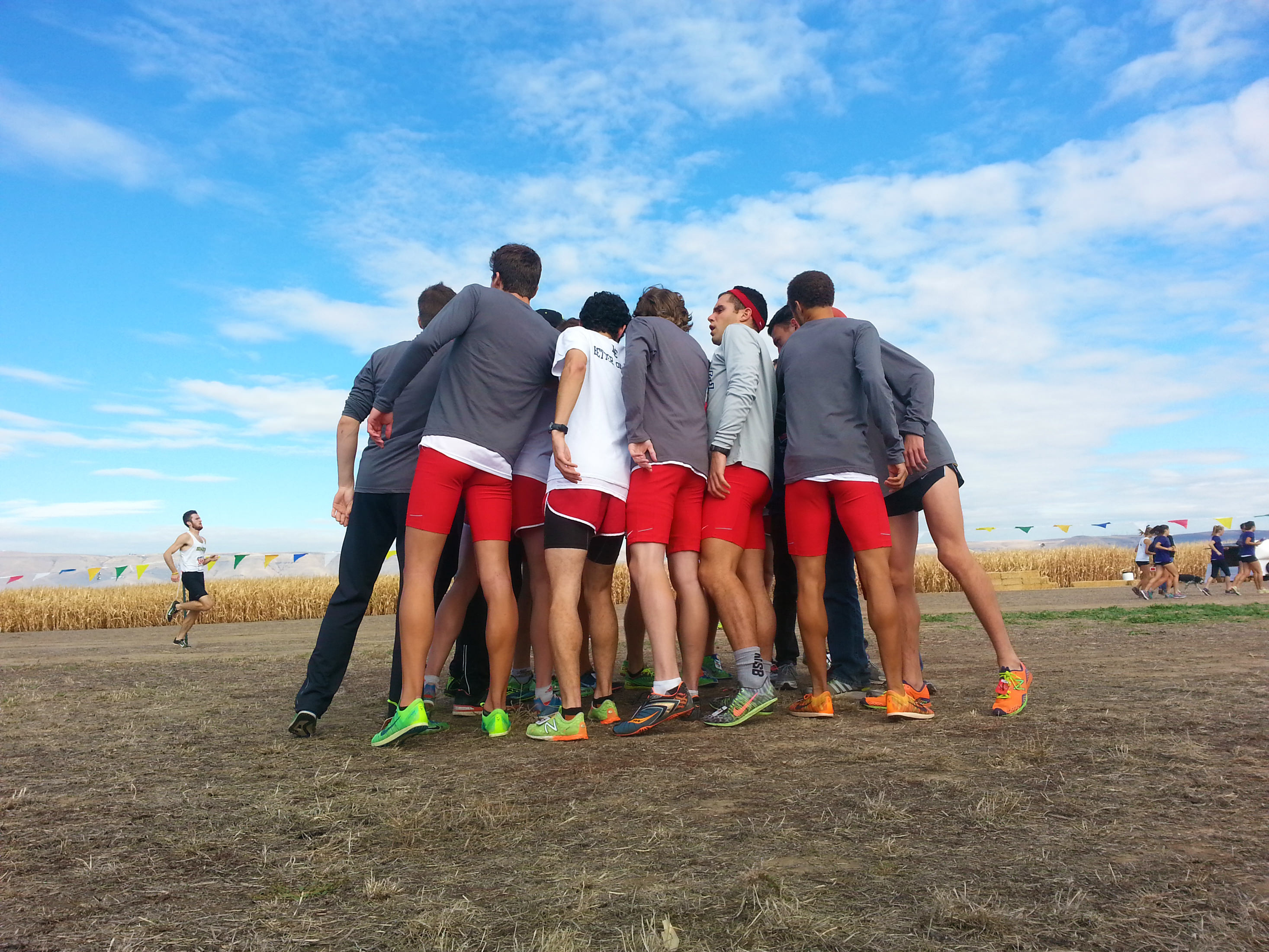 Cross country team in a huddle