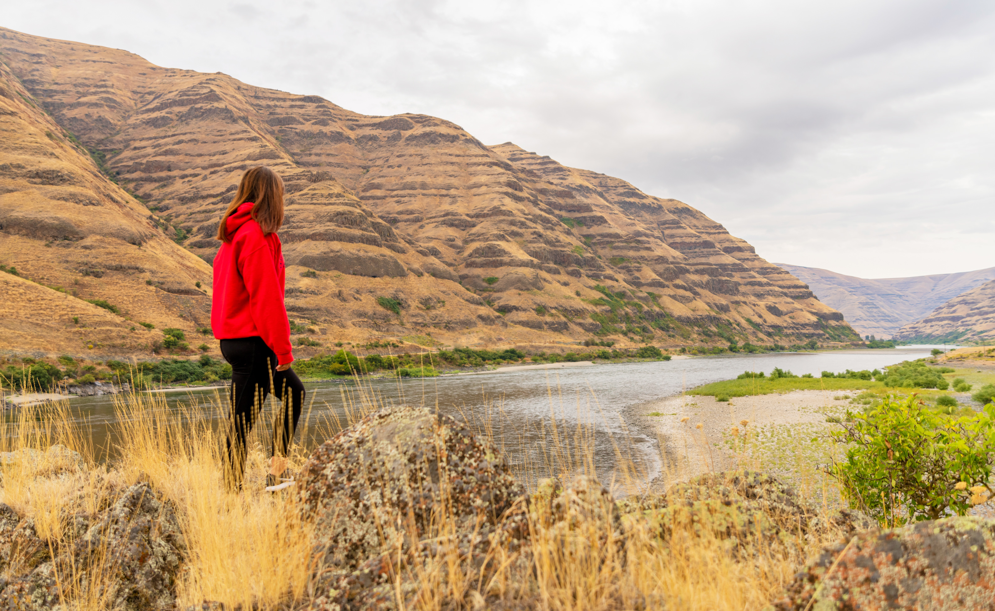 Female student looking at Snake River and hill formation