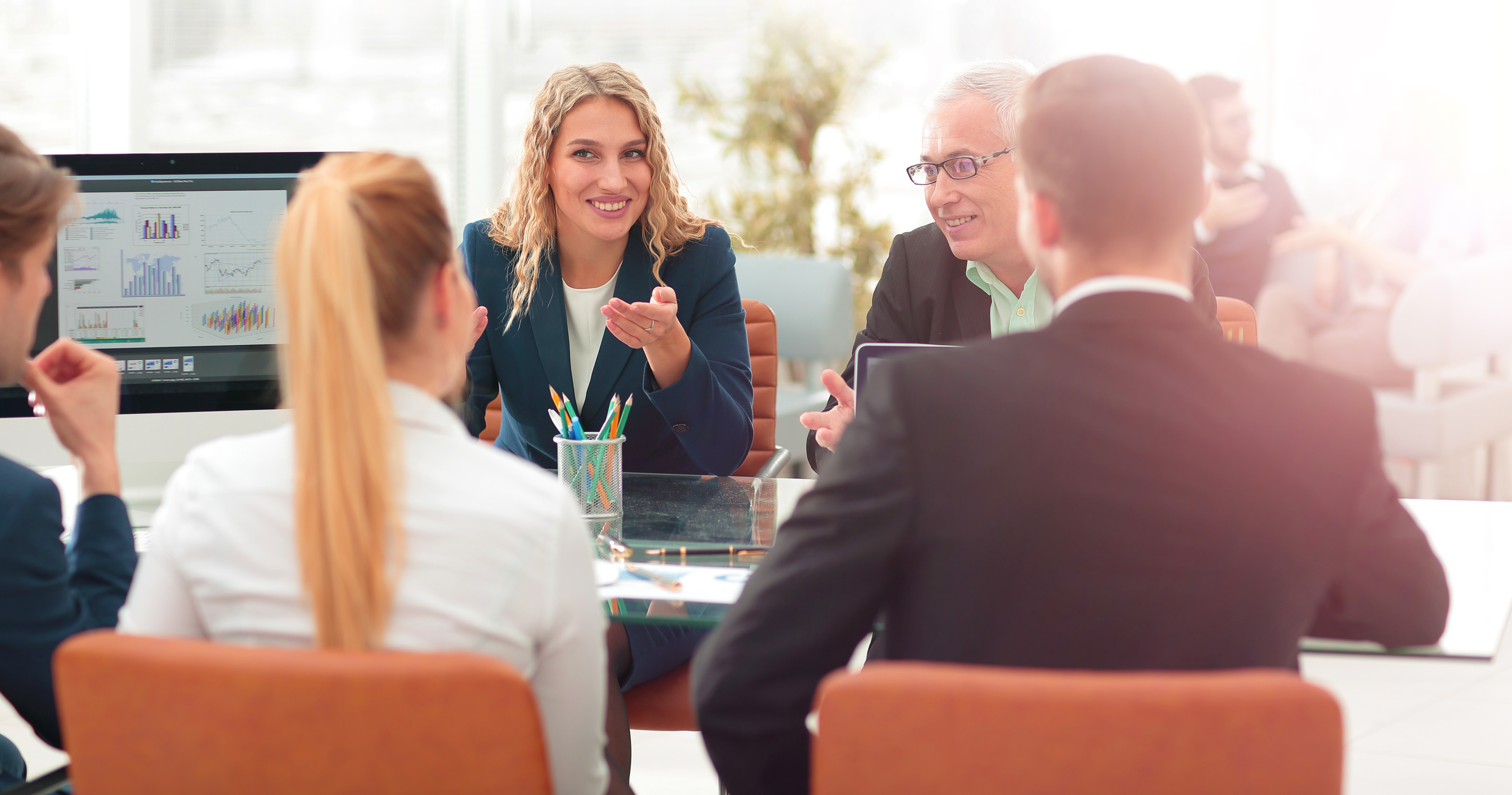 People meeting and talking around a table in a professional setting