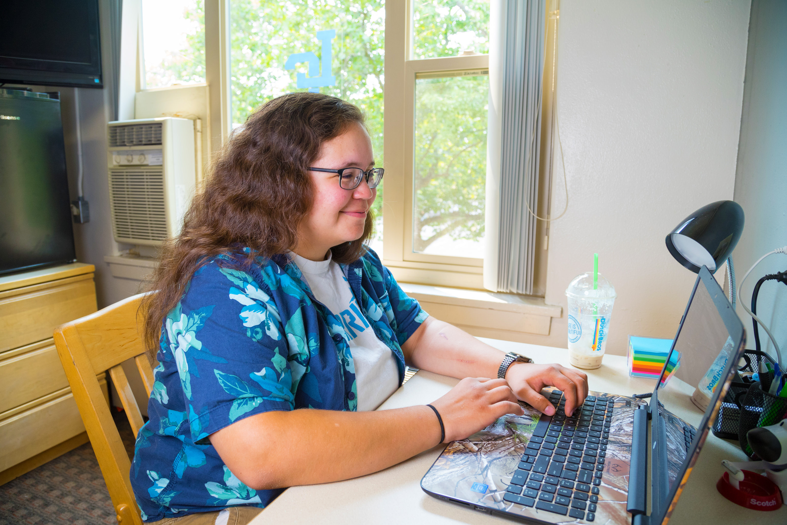 Female students at laptop in dorm