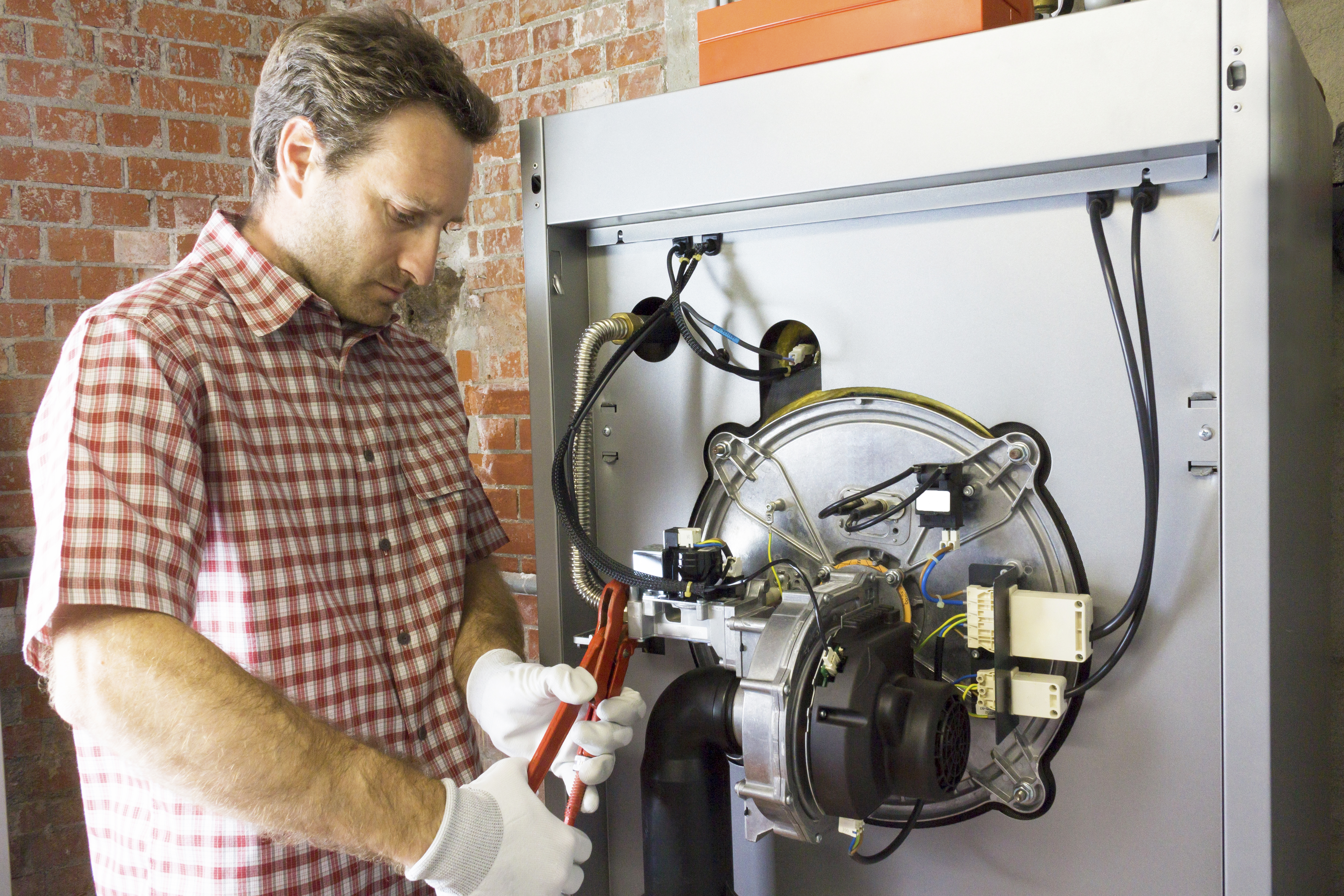 Male plumber tightening a pipe