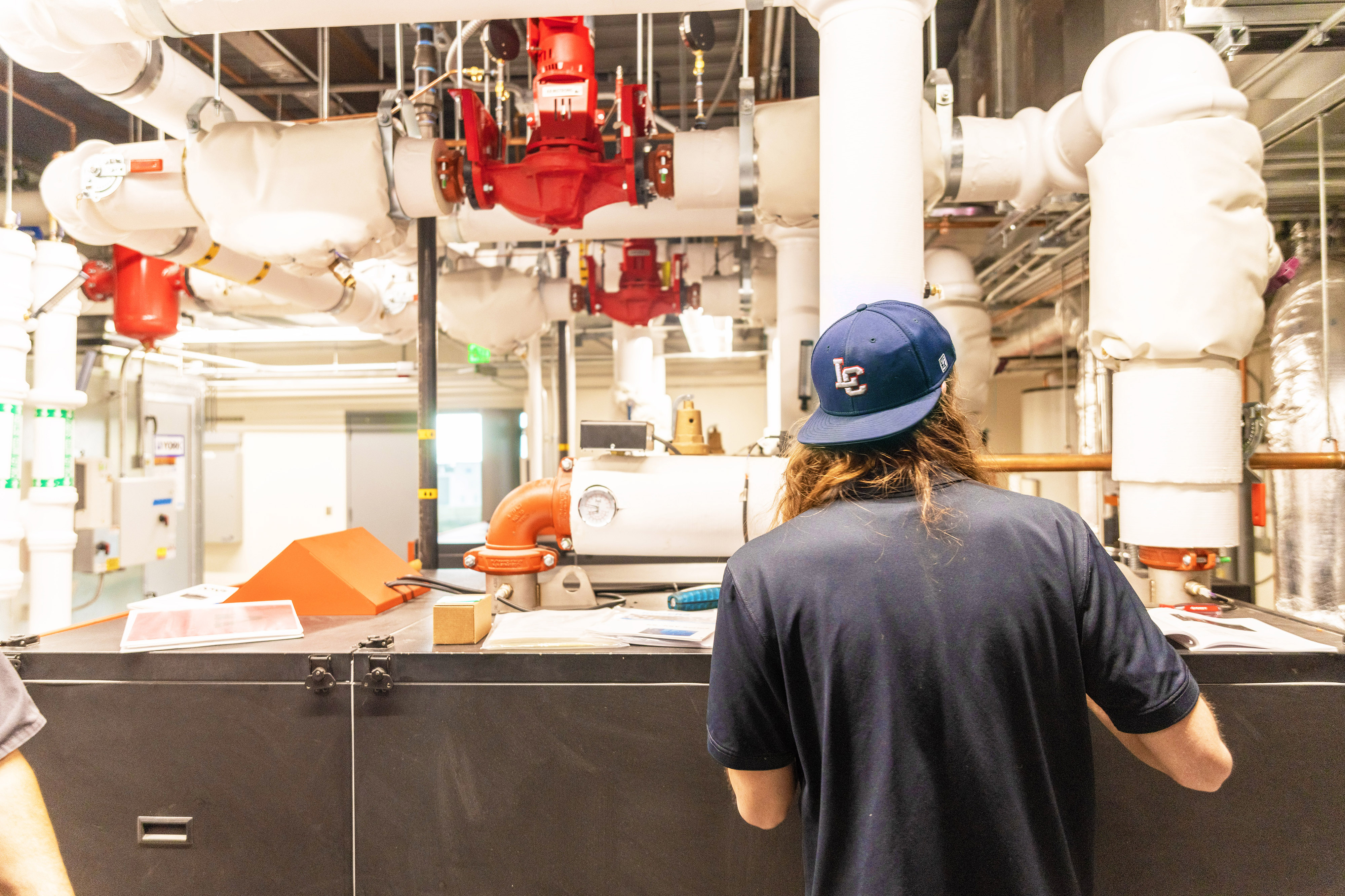 Student inside Schweitzer CTE Center looking at piping