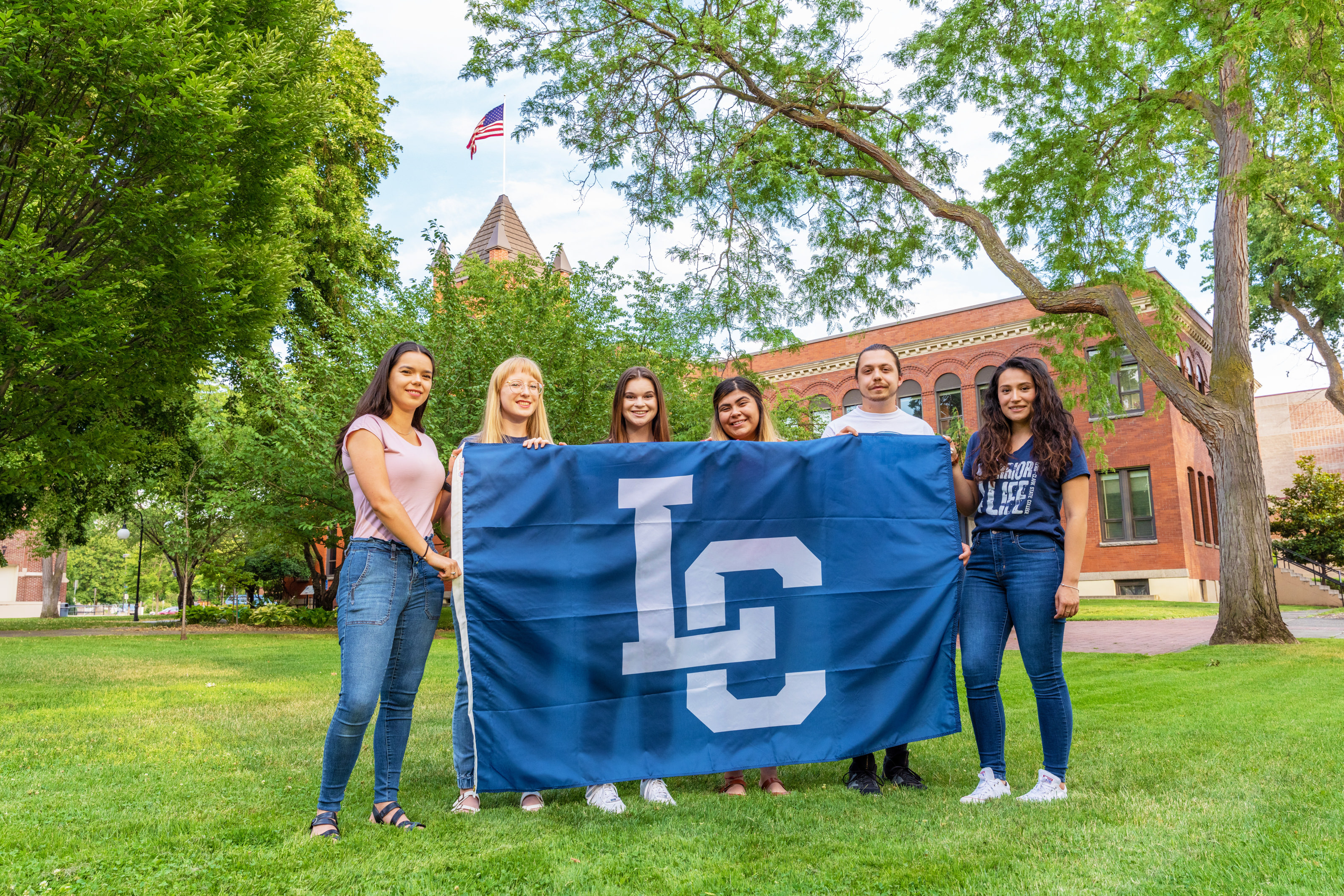 Students holding an LC State flag